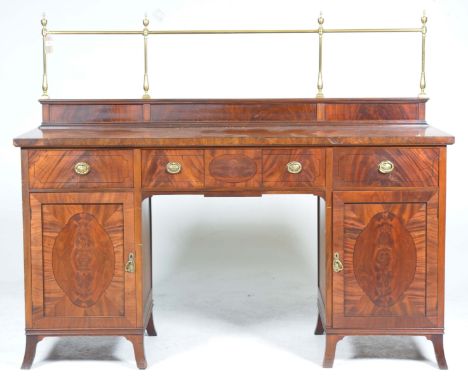 An Edwardian Regency-revival pedestal sideboard Featuring an ornate brass rail back above the cross banded and ebony strung t