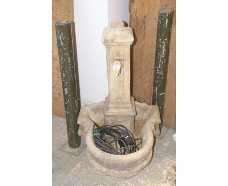 A composition garden water featureWith a square column surmounted with a tap above a bow front trough, 94cm high.