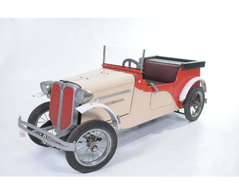 A Children's Vintage car Constructed of timber and metal, in cream and red, electrically powered but needing attention with a