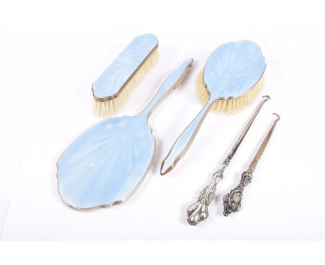An Art Deco three piece blue enamel dressing table set and two Victorian silver handled button hooksTo include clothes hairbr