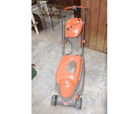 A Flymo electric lawn mowerModel 'Roller Compact 3400 with easi-reel'. 