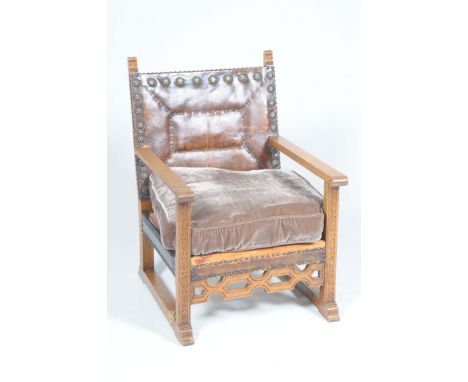 A 17th Century style oak and leather open arm chair, early 20th CenturyWith a studded padded leather back above plain arms ea
