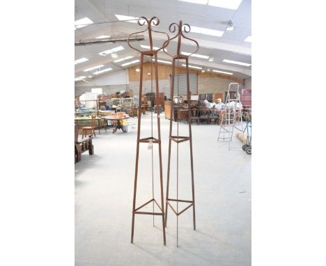 A pair of hand forged wrought iron triangular garden obelisksWith a scrolled onion top finial, height 229x23cm.