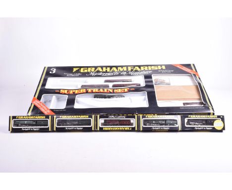 An incomplete Graham Farish 'N' gauge super train setContaining four maroon coaches and a 4-6-2 locomotive 6003 'Andrew K McC