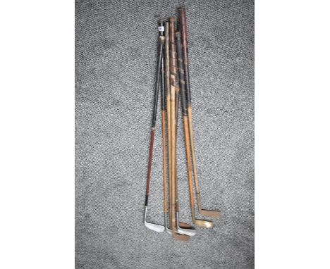 Five vintage Hickory shafted Golf Clubs along with three later Golf Irons, naming difficult to see on the earlier clubs