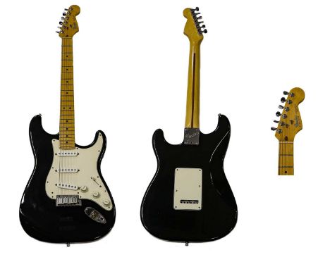 maple fingerboard and neck, black body, white scratchplate, three pickups, three control dials, five way control switch, skun
