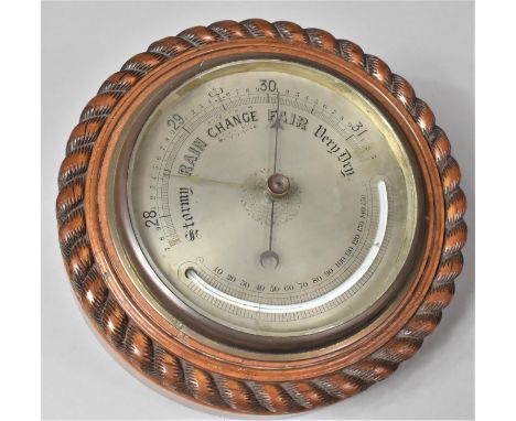 A 19th Century Aneroid Barometer with Silvered Dial and Curved Thermometer, Mounted in a Rope Carved Walnut Case, 23cm Diamet