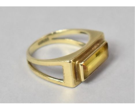 An Eastern 9ct Gold and Baguette Cut Yellow Moissanite Dress Ring. Rectangular Mount Leading to Triagnular Fret Cut Shoulders