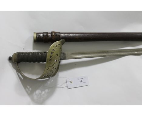 AN OFFICERS SWORD. An 1897 pattern officers sword, complete with a brown leather field scabbard. The clean blade of 32" lengt