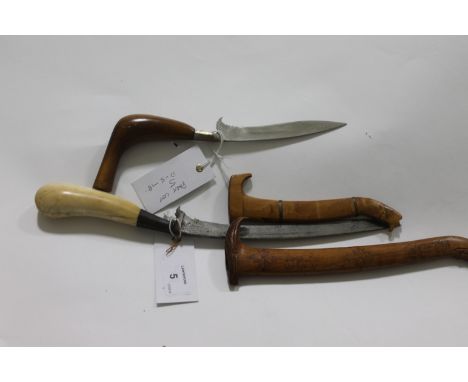 TWO RENCONG ACEH KNIVES. An older Sumatran knife with ivory hilt and drooped blade of 8", having some light decoration eviden