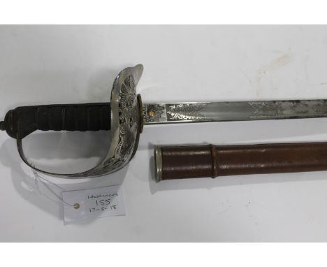 AN OFFICERS SWORD. An 1897 pattern officers sword with brown leather field scabbard. Marked Robert Mole on the 32.1/4" blade,