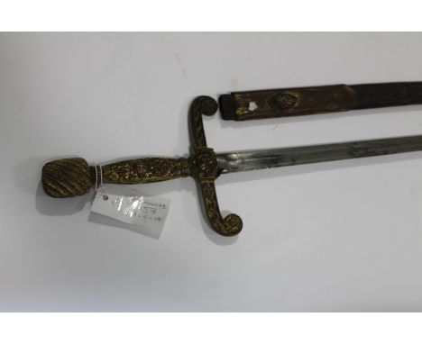 A MASONIC SWORD.A French sword in th e Masonic style, with gilt decorated mounts and swept forward quillions. The blade of do