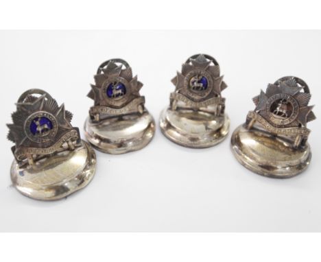FOUR BEDFORDSHIRE REGT MENU HOLDERS. Three in Silver and Enamel with a London hallmark for 1922, one Chester hallmark for 190