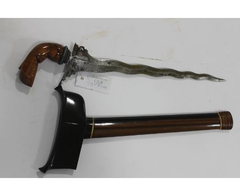 A KRIS .An attractive Kris with a 14" wavy-edged blade and carved wooden Garuda Bird hilt. Bi-wood scabbard with carved throa