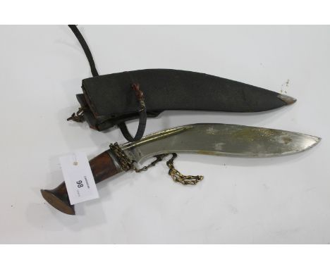 A KUKRI. A WW11 period fighting Kukri, complete with scabbard and skinning knives. A very clean blade of 11.3/4" length, with