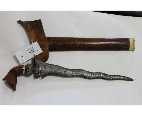 A KRIS. A Kris with Garuda Bird hilt and watered steel 11 .3/4" blade. With decorative grip mount and banded wooden scabbard.
