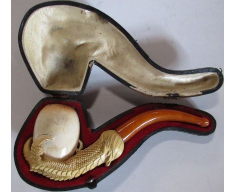A cased meerschaum pipe, carved as a dragons claw holding an egg
