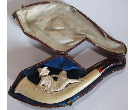 A cased meerschaum pipe, carved as a reclining male figure