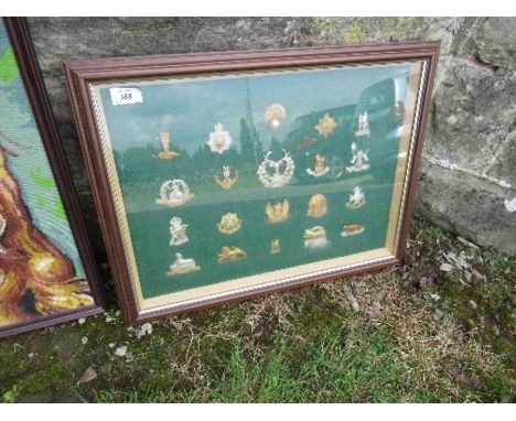 A framed collection of regimental cap badges, together with a tapestry of a dog