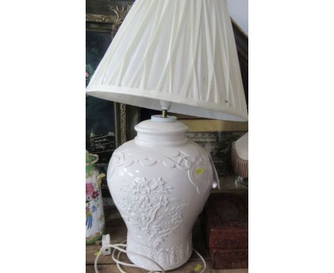 A white pottery lamp base, with embossed decoration, height including shade 26ins