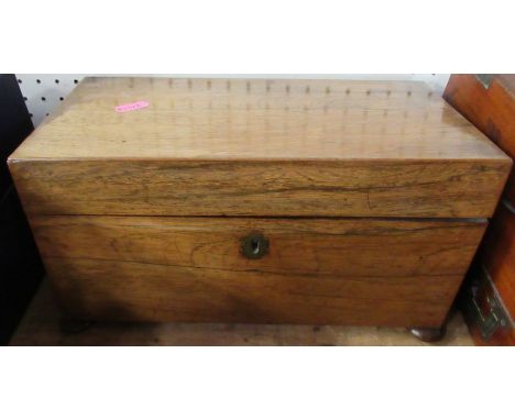 A 19th century rosewood tea caddy, of rectangular form, the interior fitted with a pair of covered boxes and a central well f