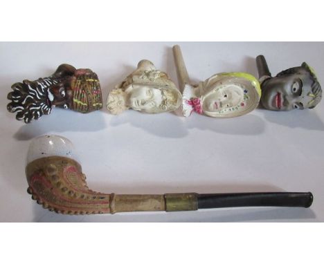 A Gambier clay pipe, carved with a woman wearing a bonnet, together with another Gambier Jacob pipe, three others marked mark
