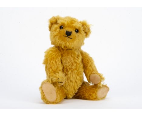 A fine Chiltern 1930s Hugmee teddy bear, with bright golden mohair, orange and black glass eyes, pronounced clipped muzzle, b