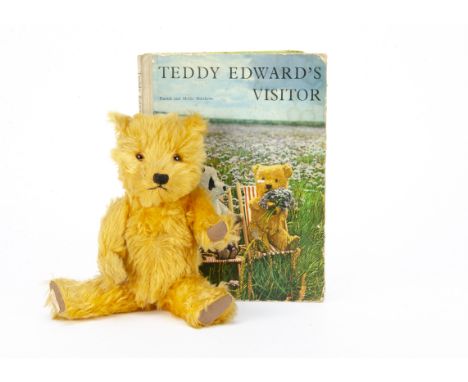 A post-war Chiltern Hugmee teddy bear,  with golden mohair, orange and black glass eyes, black stitched nose and mouth, swive