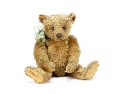 An early Steiff centre-seam teddy bear circa 1909, with cinnamon mohair, black boot button eyes, central seam down front of f