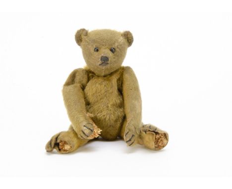 A Steiff teddy bear circa 1910, with short golden mohair, black boot button eyes, pronounced clipped muzzle, black stitched n