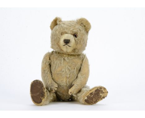 A post-war Chiltern Ting-a-Ling type teddy bear,  with beige mohair, one orange and black glass eyes, short cream mohair muzz