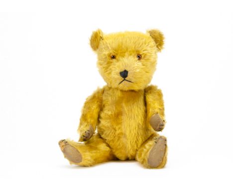 A 1950s Chiltern Hugmee teddy bear,  with golden mohair, orange and black plastic eyes, black stitched nose, mouth and claws,