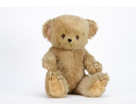 An unusual post-war Chiltern teddy bear cub,  with pale pink synthetic mix plush, heart shaped face mask, dark orange and bla