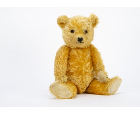 A fine Chiltern 1930s Hugmee teddy bear, with bright golden mohair, orange and black glass eyes, pronounced clipped muzzle, b