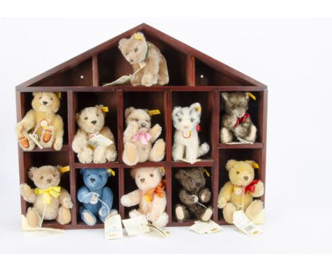 Historic Steiff Miniatures: ten teddy bears and a cat including Dicky and Jackie in house shaped wooden shelf —22 1/2in. (57c