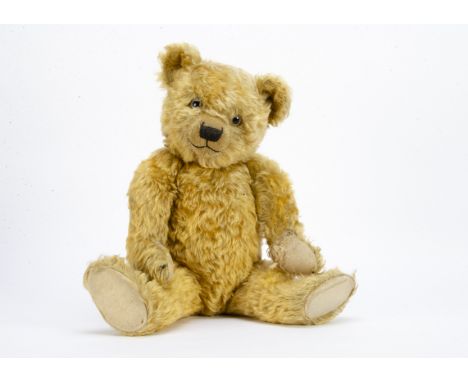 A Chiltern 1930s Hugmee teddy bear,  with golden mohair, clear and black glass eyes with remains of brown painted backs, pron