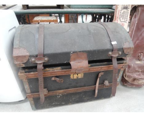 A vintage dome topped travel trunk