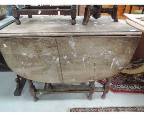 An early 20th Century oak twist gate leg dining table