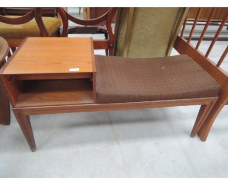 A vintage teak telephone seat