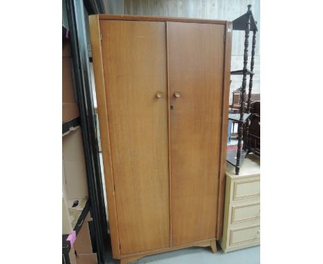 A vintage golden oak wardrobe, labelled Austinsuite