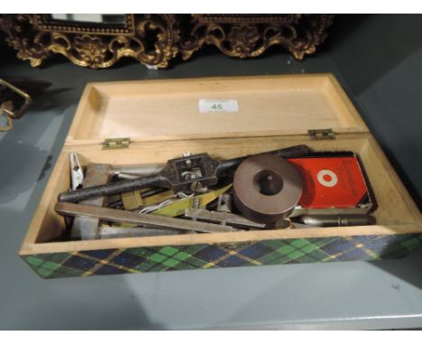 A small collection of tools/instruments including taps and dies 