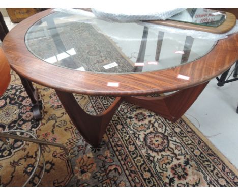 A vintage sapele or teak glass top coffee table