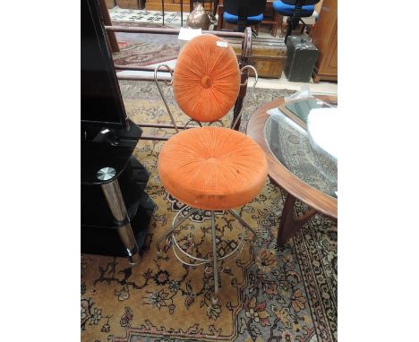 A vintage wirework stool/chair with orange upholstery