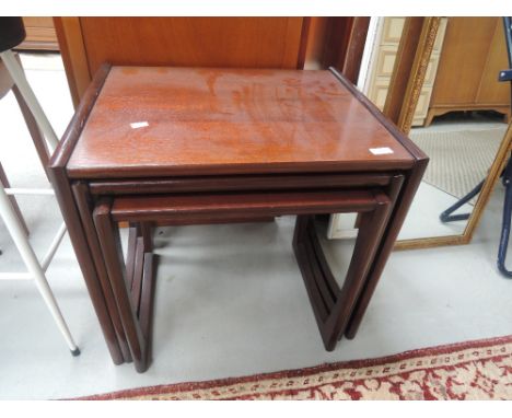 A vintage mahogany nest of three tables