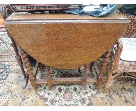 An early to mid 20th Century oak twist gate leg table