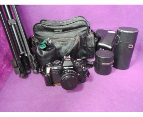 A Nikon F301 camera with four lenses a Nikkor Series E 50mm, a Nikkor 28mm, a Nikkor 35-70mm, a Hanimmex zoom C Macro 80-200m