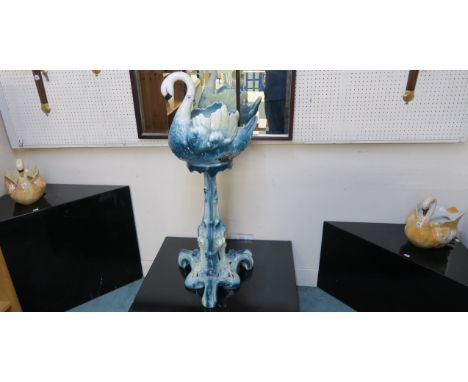 A ceramic swan jardiniere on pedestal, 108cm high and two swan planters (3) Condition Report: Available upon request