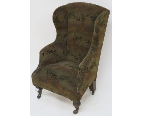 A childs wingback upholstered armchair with ceramic castors, 72cm high Condition Report: Available upon request