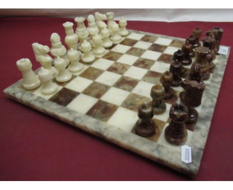 C20th polished marble chess board and pieces, board 36cm square 