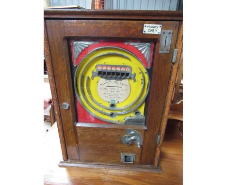 1960's oak cased Oliver Whales Penny in the Slot Alwin flicker machine, W45cm D18cm H63cm 